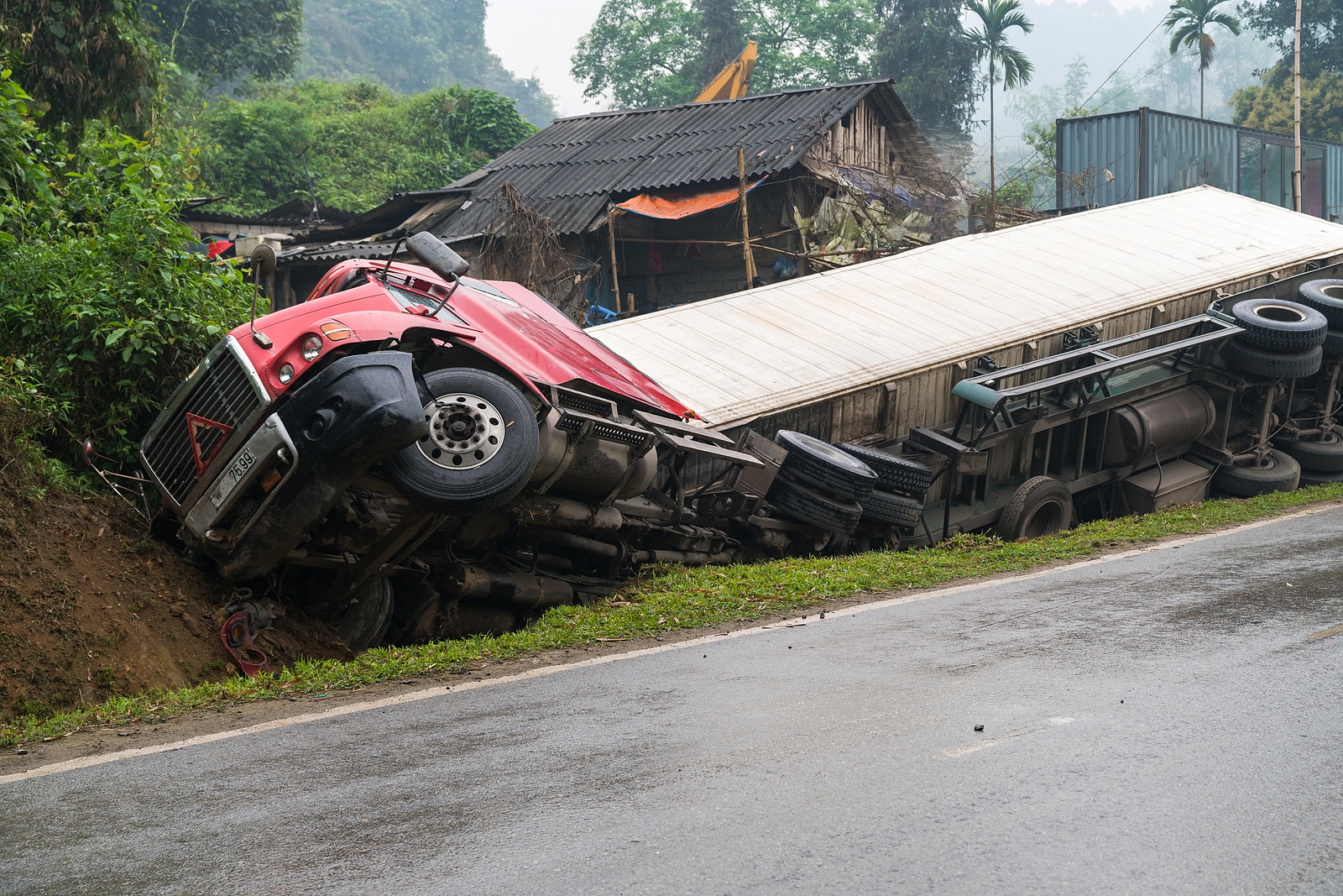 Truck overturned and lying in ditch on its side